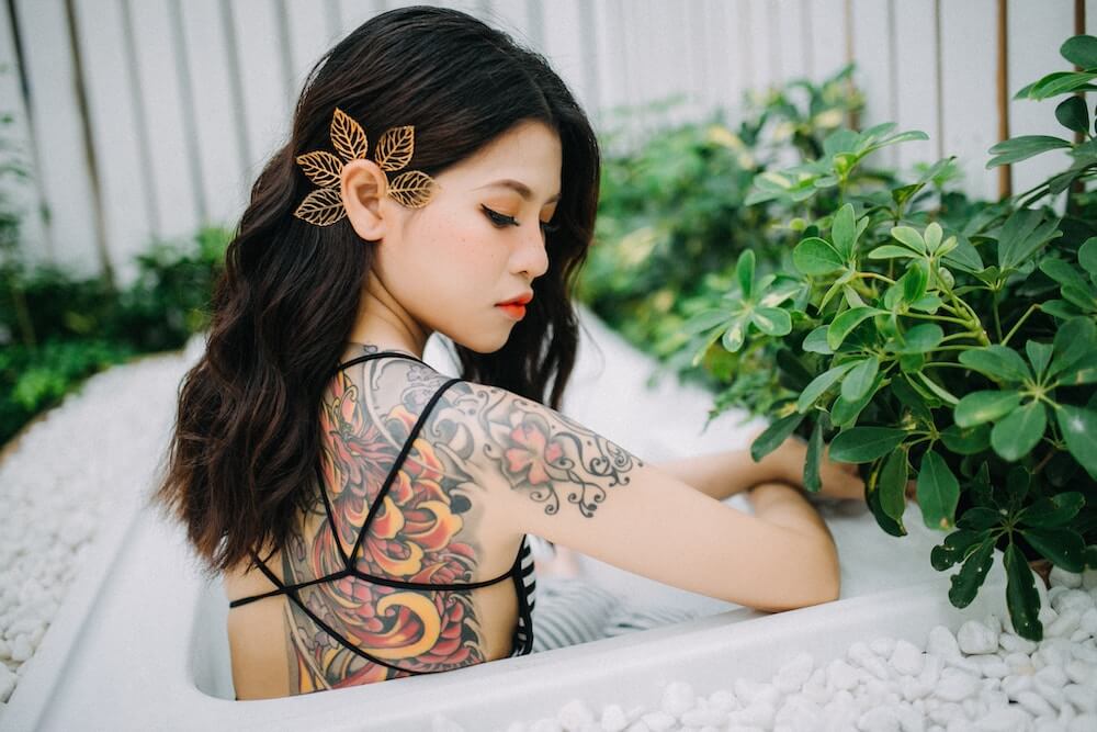 Tattoed Thai girl in bathtub